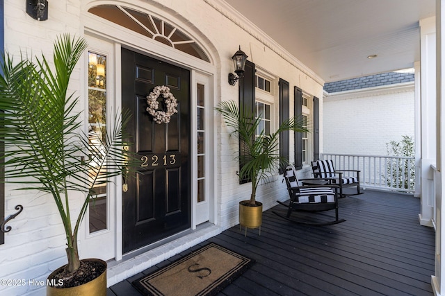 view of exterior entry with covered porch