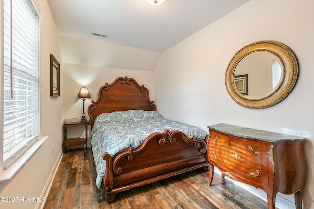 bedroom featuring vaulted ceiling and dark hardwood / wood-style flooring