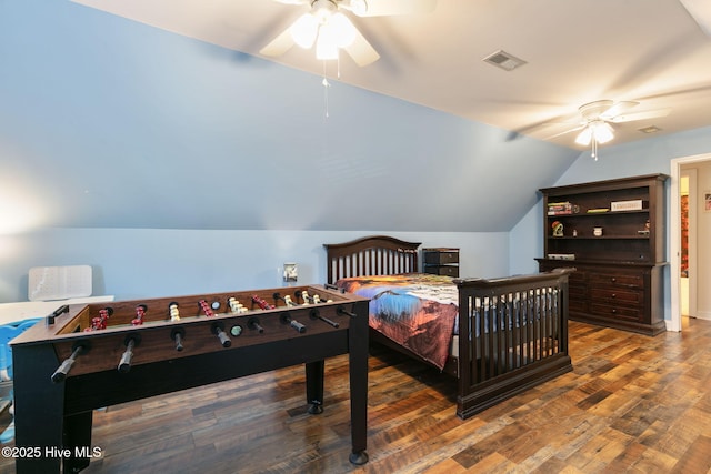 bedroom with dark wood-type flooring, ceiling fan, and vaulted ceiling