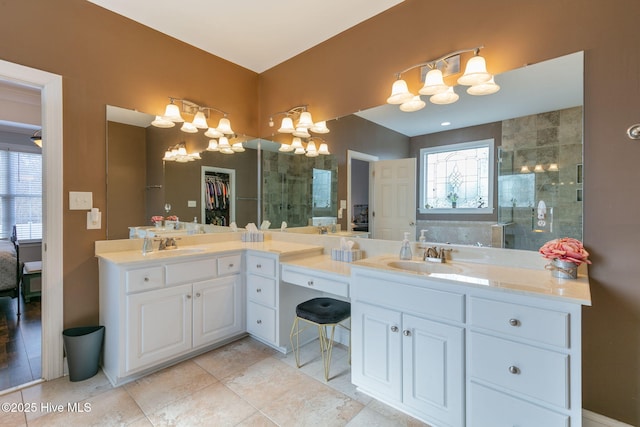 bathroom with a shower with door, vanity, tile patterned flooring, and an inviting chandelier