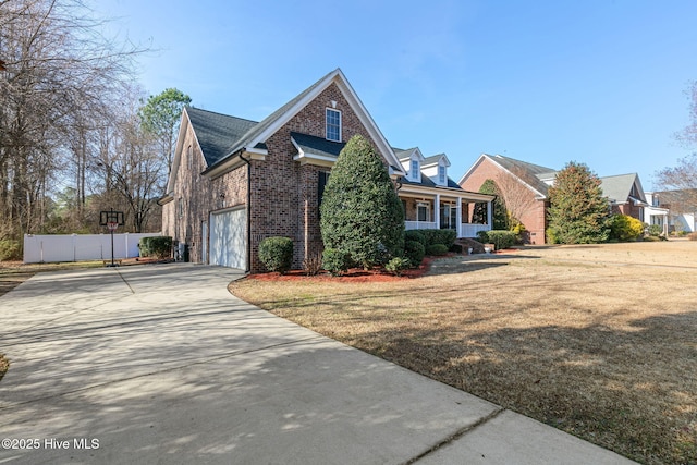 view of front of property with a garage, a front yard, and a porch