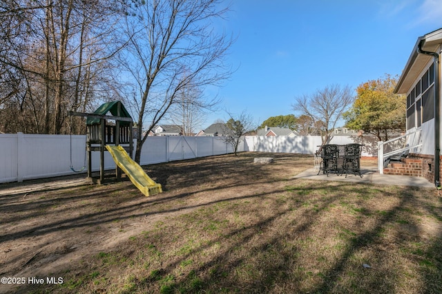 view of yard featuring a patio area and a playground