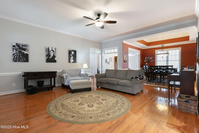 living room with ceiling fan, ornamental molding, and hardwood / wood-style floors