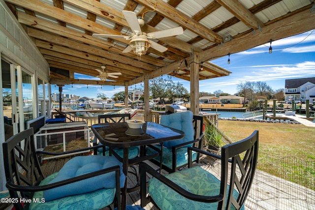 view of patio / terrace featuring a water view and a ceiling fan