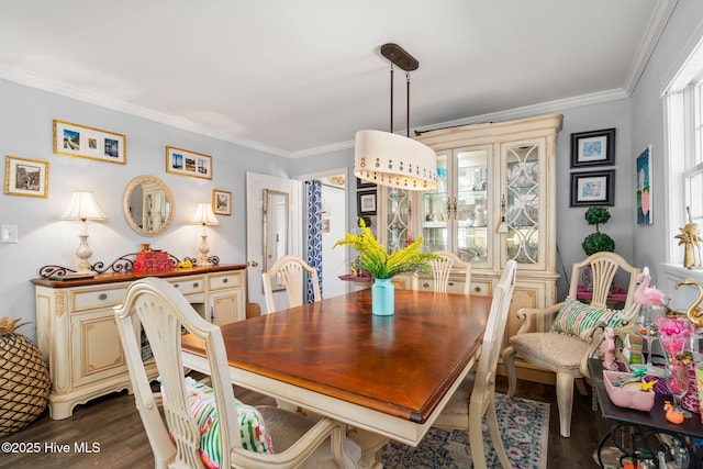 dining space with ornamental molding and dark wood-type flooring