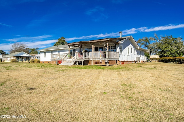 back of house featuring crawl space, covered porch, and a yard