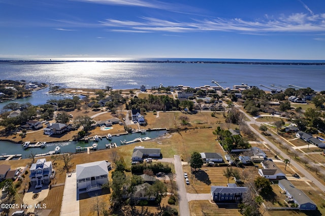 drone / aerial view with a residential view and a water view