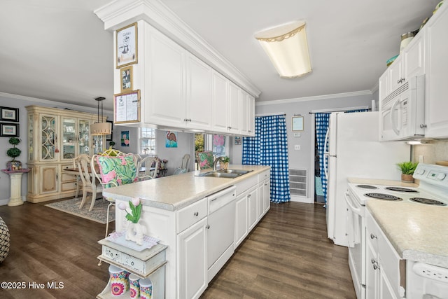 kitchen featuring white appliances, a sink, white cabinets, light countertops, and crown molding