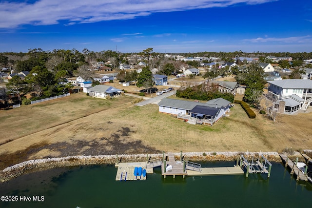 drone / aerial view featuring a water view and a residential view