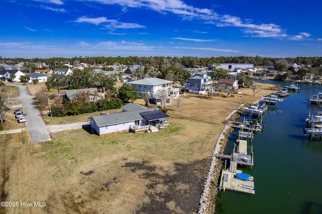 drone / aerial view with a water view and a residential view