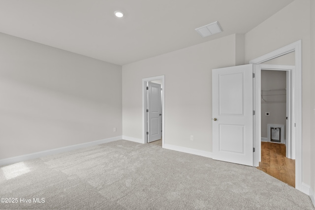 1200 Calabash Station Blvd NW, Calabash, NC 28467 - unfurnished bedroom with carpet, a spacious closet, baseboards, and recessed lighting
