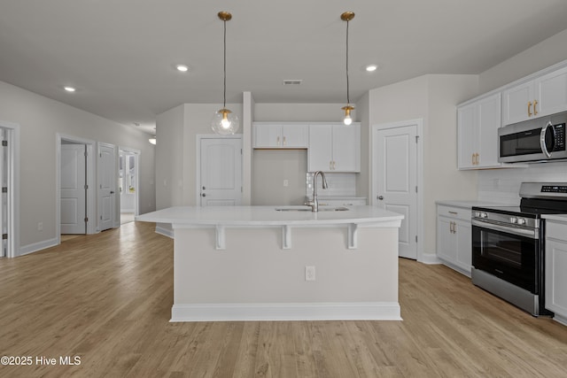 1200 Calabash Station Blvd NW, Calabash, NC 28467 - kitchen featuring appliances with stainless steel finishes, a sink, tasteful backsplash, light wood finished floors, and recessed lighting