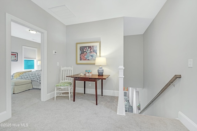 hallway with light colored carpet