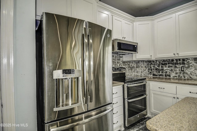 kitchen with appliances with stainless steel finishes, light stone countertops, decorative backsplash, and white cabinets