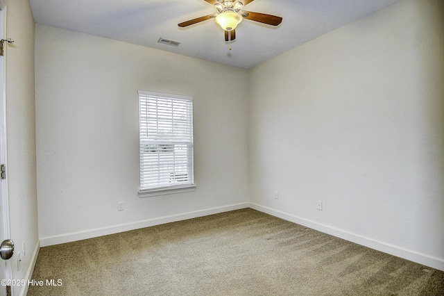 empty room with ceiling fan and carpet