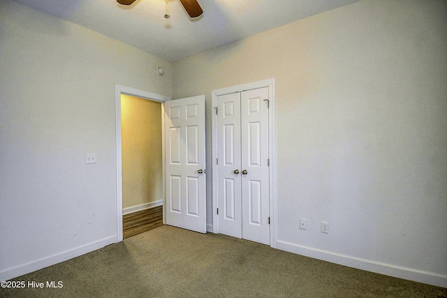 unfurnished bedroom with ceiling fan, carpet floors, and a closet