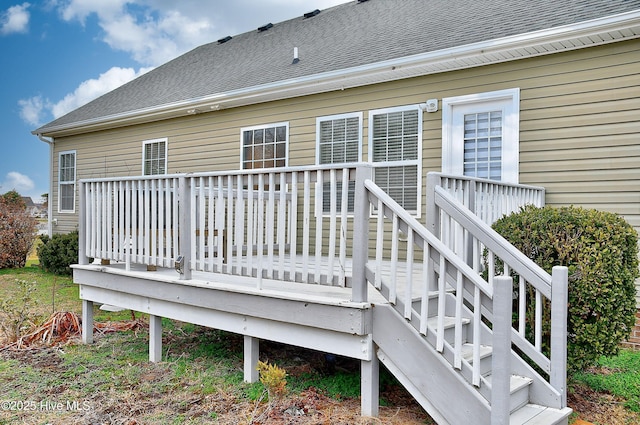 rear view of house featuring a deck