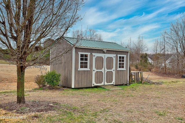 view of outbuilding with a yard