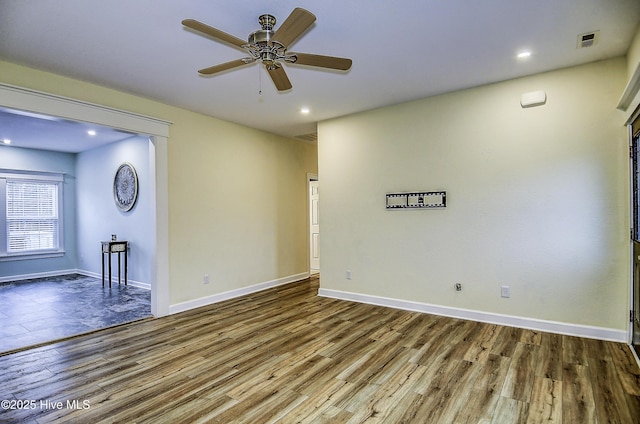 spare room featuring ceiling fan and wood-type flooring