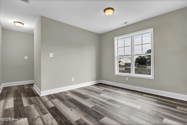 spare room with dark wood-type flooring