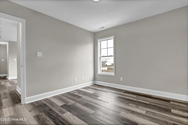 empty room featuring dark wood-type flooring