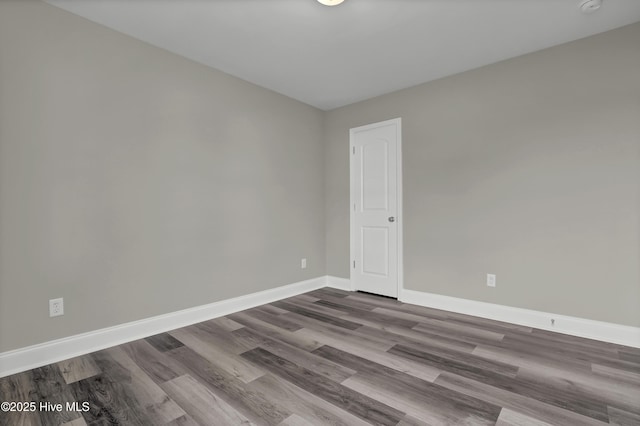 unfurnished room with wood-type flooring