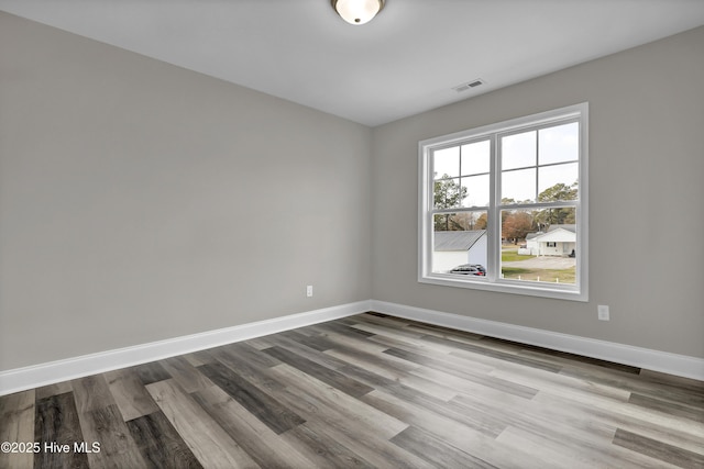 unfurnished room featuring hardwood / wood-style floors