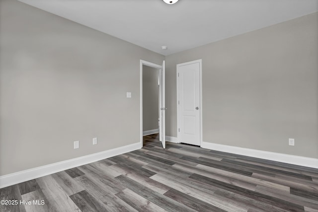 empty room with dark wood-type flooring