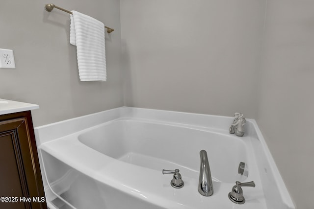 bathroom featuring vanity and a bath