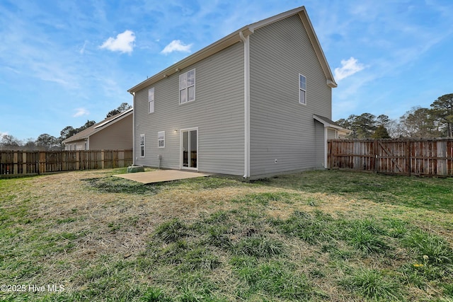 rear view of house featuring a patio and a lawn