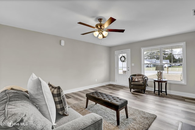 living room with ceiling fan and light hardwood / wood-style floors