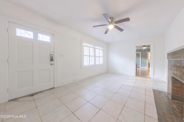 entryway with light tile patterned floors and ceiling fan