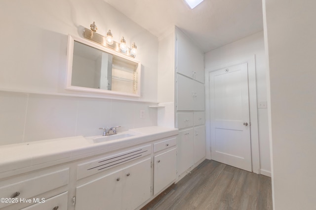 bathroom with vanity and hardwood / wood-style flooring