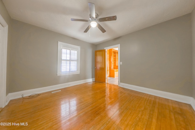 empty room with hardwood / wood-style flooring and ceiling fan