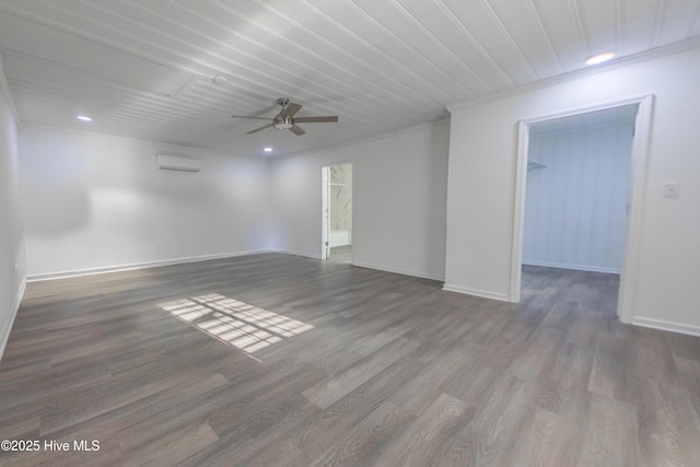 spare room featuring hardwood / wood-style flooring, ornamental molding, a wall mounted AC, and ceiling fan