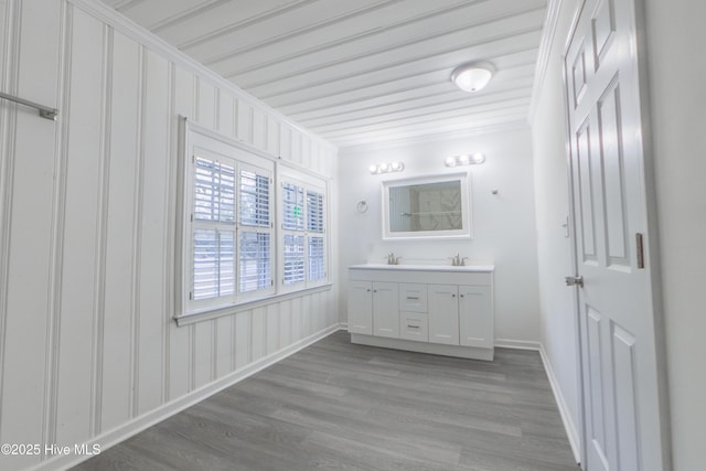 bathroom with vanity, hardwood / wood-style flooring, and ornamental molding