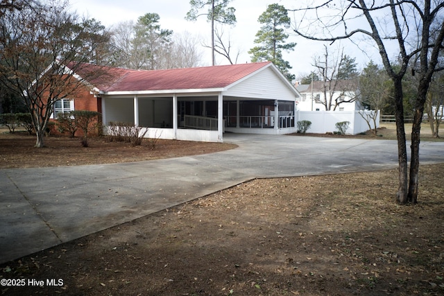 view of side of home with a sunroom