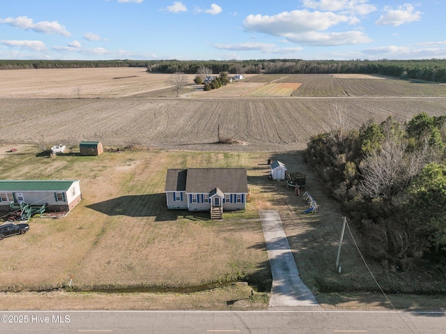 birds eye view of property with a rural view