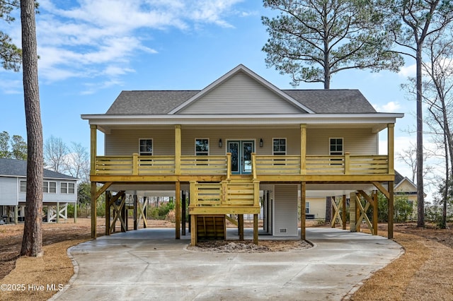 coastal inspired home featuring a carport and covered porch