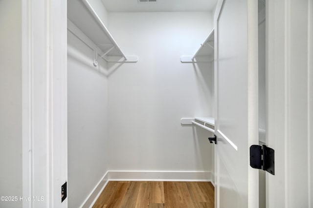 walk in closet featuring hardwood / wood-style flooring