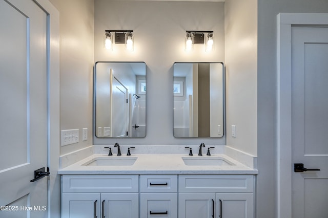 bathroom featuring a sink and double vanity