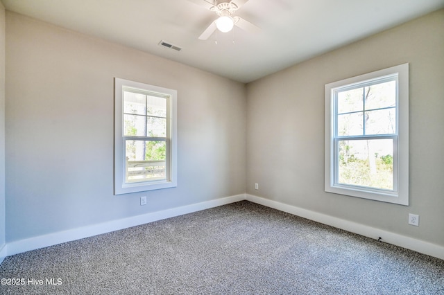 unfurnished room with ceiling fan and carpet