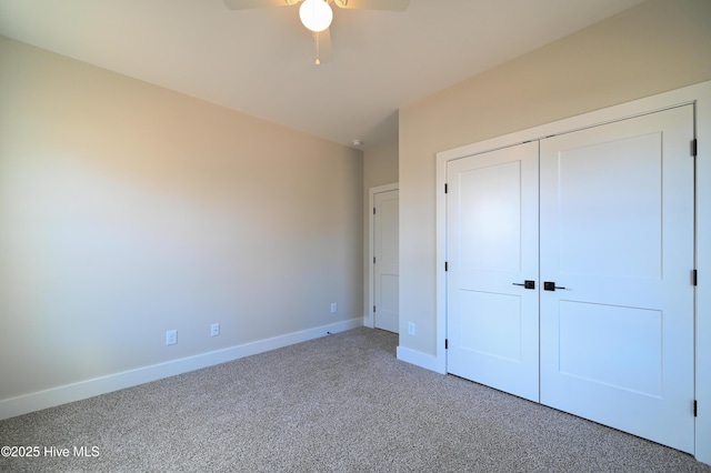 unfurnished bedroom with a ceiling fan, baseboards, carpet floors, and a closet