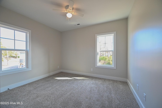 unfurnished room featuring ceiling fan and carpet