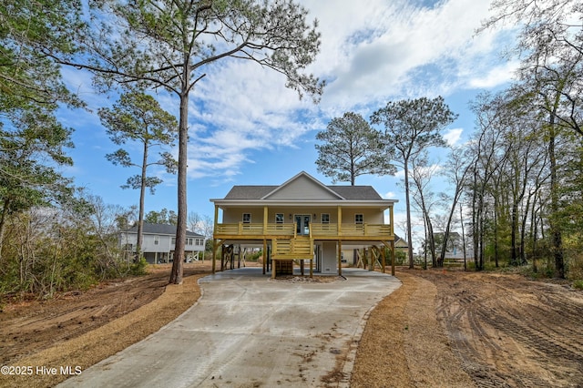 view of front of house featuring a carport and covered porch