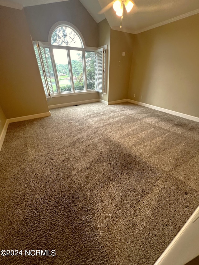 carpeted spare room with ornamental molding, lofted ceiling, and ceiling fan