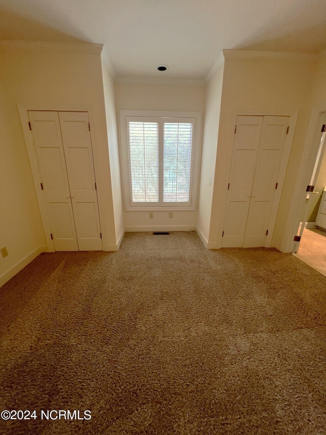 unfurnished bedroom with crown molding and light carpet