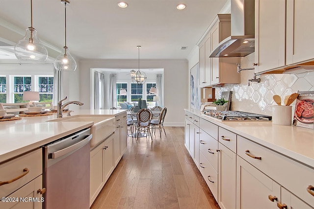 1024 Peace St Lot 73, Leland, NC 28451 - kitchen featuring appliances with stainless steel finishes, wall chimney exhaust hood, light countertops, light wood-type flooring, and recessed lighting