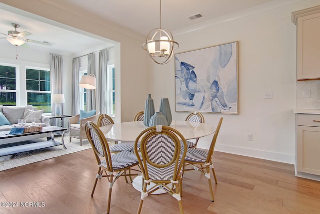 1024 Peace St Lot 73, Leland, NC 28451 - dining room featuring light wood-type flooring, a ceiling fan, baseboards, and crown molding