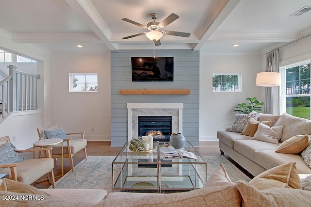 1024 Peace St Lot 73, Leland, NC 28451 - living room with wood finished floors, healthy amount of natural light, beamed ceiling, a glass covered fireplace, and coffered ceiling